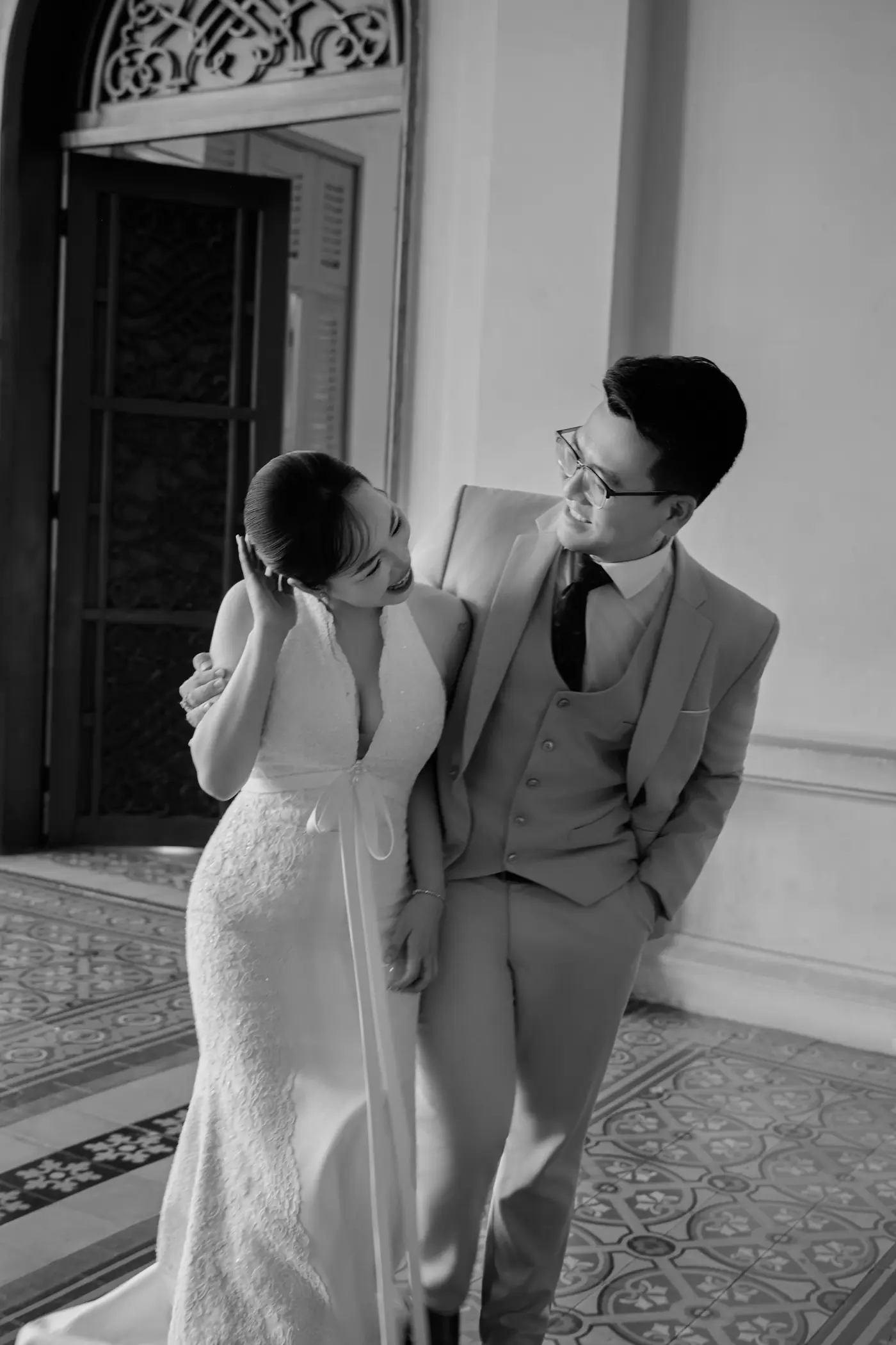 Black and white: the couple laughing in a doorway