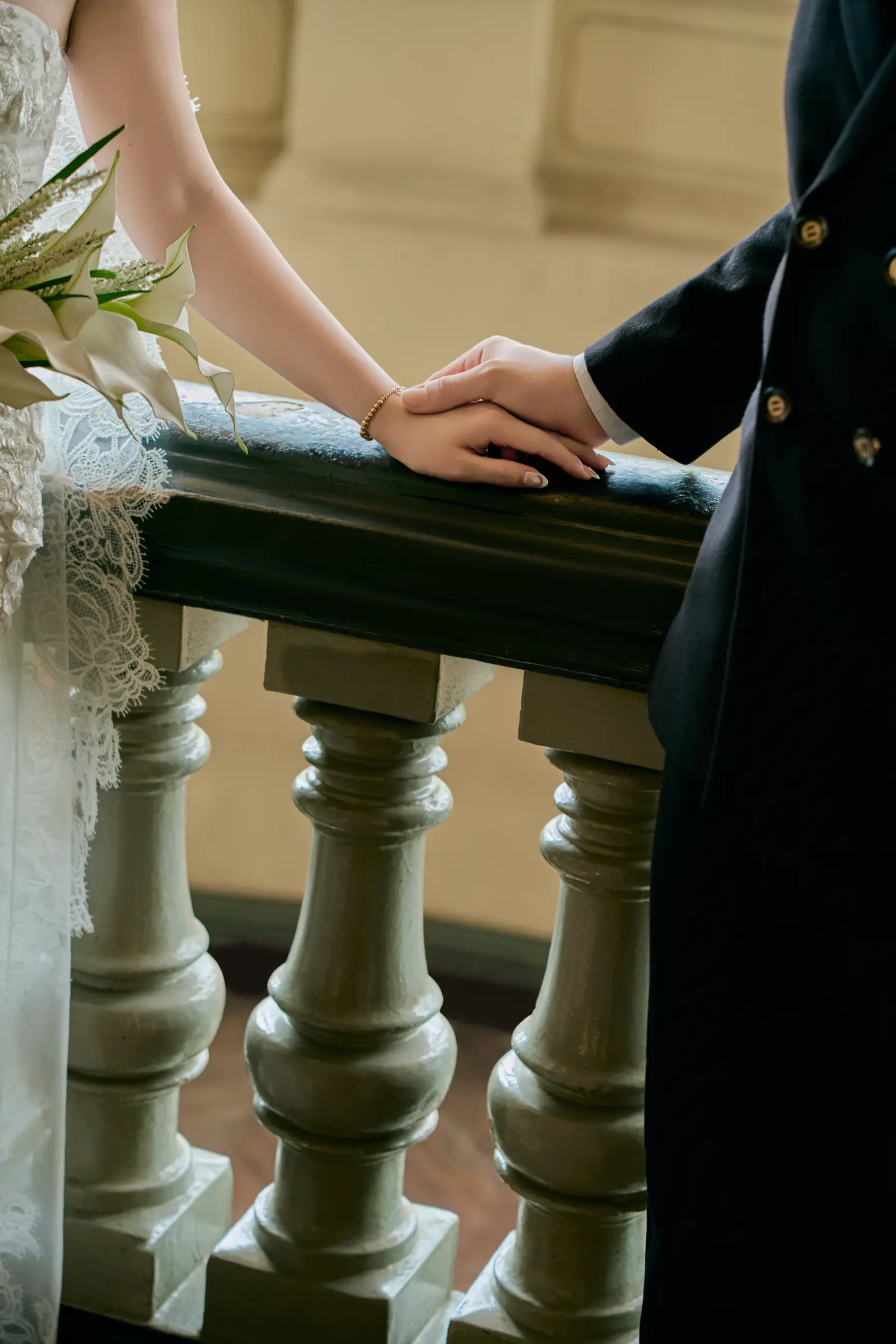 Her hand resting on his, on a stone balustrade